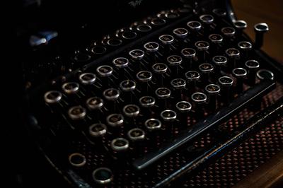 Image contains a typewriter with a rose gold overlay.