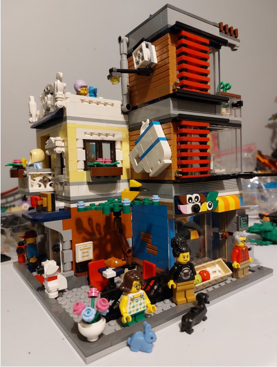Picture depicting a coffee shop and pet store with people and animals having a fun time