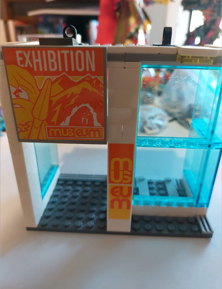 Beginning stages of a lego museum being built on a table.